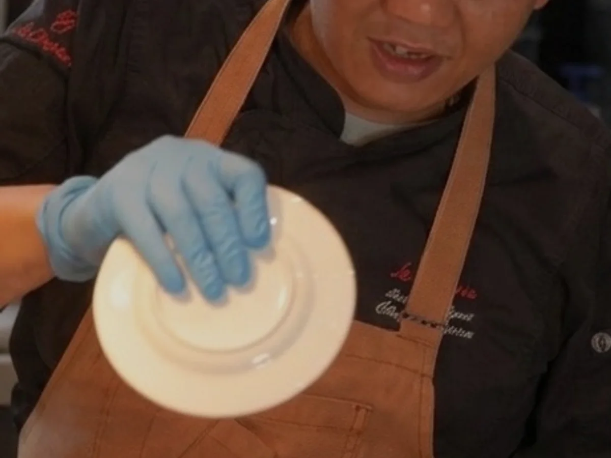 Chef Azmi finishing a dish in the private kitchen